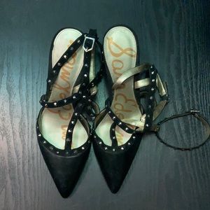 Strapped studded black heels.